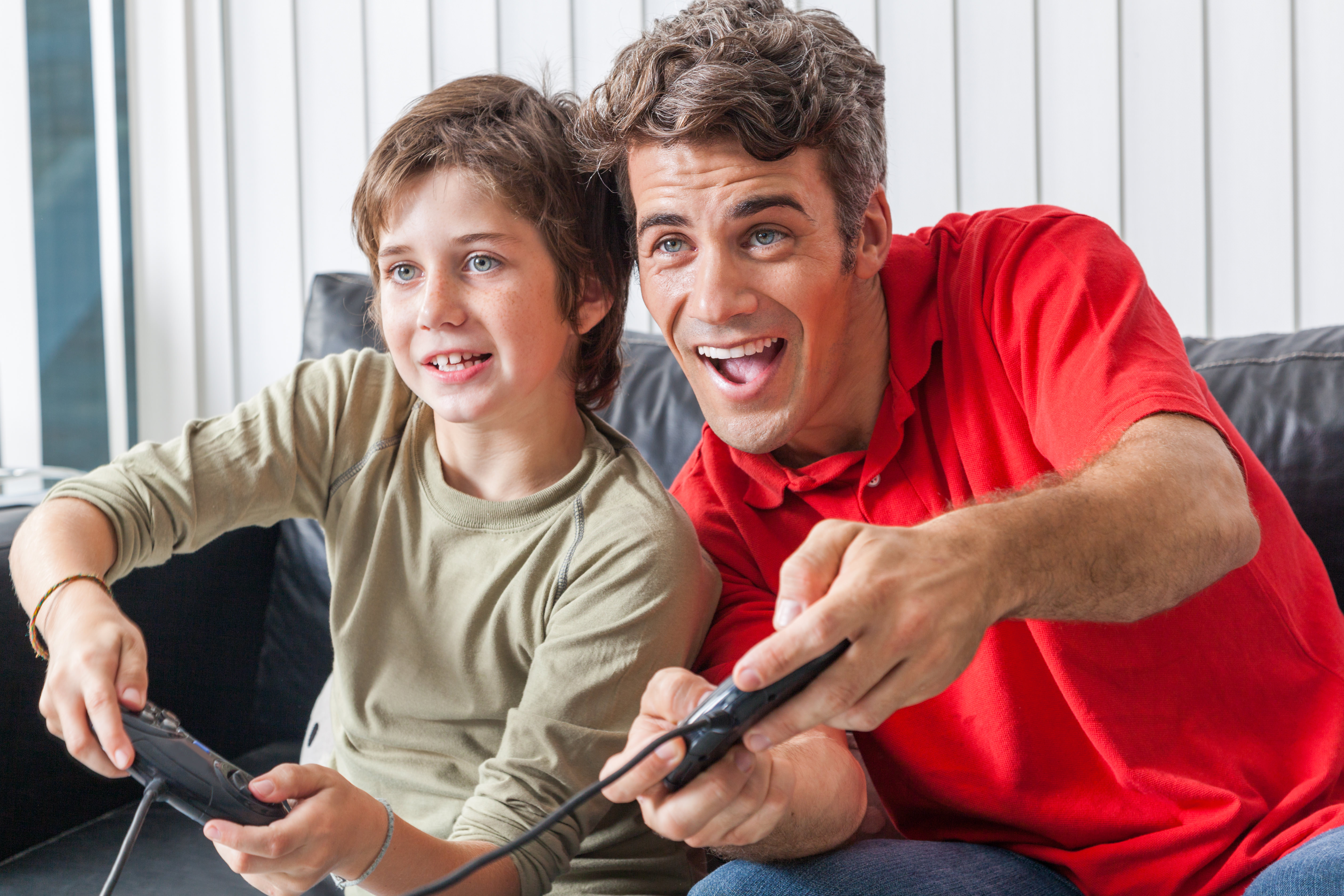 father and son playing video game, happy smile